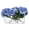 Front view of blue faux hydrangeas arranged in a modern clear glass trough vase.