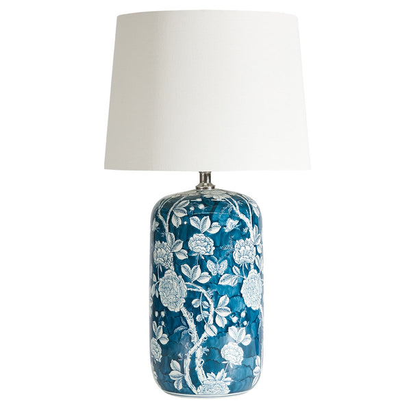 Ink blue and white hand-painted ceramic table lamp with modern floral design and woven white cotton shade
