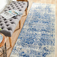 Isla White and Navy long runner styled on timber flooring beside a grey upholstered bench