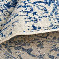 Isla White Navy Round Rug folded to show polypropylene pile and woven backing
