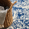 Navy medallion pattern of Isla White Navy Round Rug styled with woven basket