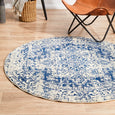 Isla White Navy Round Rug styled with tan leather chair and timber furniture