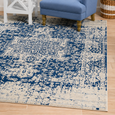 Isla White Navy Rug styled with blue upholstered armchair and coastal décor in a relaxed Hamptons living room