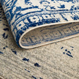 Folded corner of Isla White Navy Rug highlighting flexible woven construction and backing