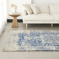 Isla White Navy Rug styled with white upholstered armchair and coastal décor in a relaxed Hamptons living room