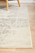Corner detail of the Isla White Silver Rug showing the soft distressed texture and neutral palette