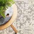 Isla White Silver Rug styled beneath a timber side table highlighting the soft distressed pattern