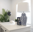 Elegant jar-shaped ceramic table lamp with white fabric shade for bedroom or living room styling
