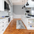 Keira Grey Runner styled in a bright Hamptons kitchen with timber herringbone flooring and white cabinetry