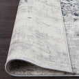 Rolled corner detail of the Keira Grey Runner showing flexible construction and soft woven backing