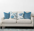 Knightsbridge natural linen sofa styled with blue and white cushions in a classic Hamptons living