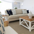 Knightsbridge natural linen sofa with navy and white cushions styled in a light-filled Hamptons living room.