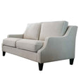 Angled view of Knightsbridge natural linen sofa with white piping, curved arms and timber legs.