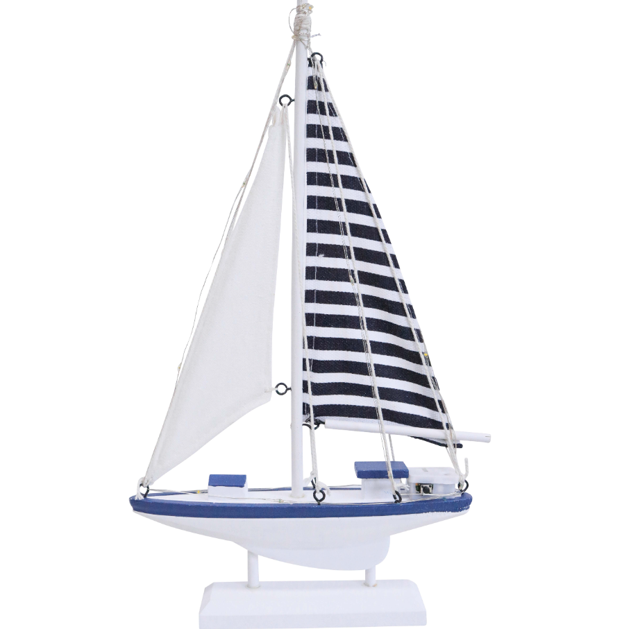 Small blue and white decorative sailboat with fabric sails and nautical detailing, styled as a coastal home accent.