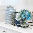 blue and white table lamp styled on console with silver clock and blue hydrangea arrangement