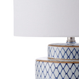 detail of white fabric shade and porcelain lamp base connection