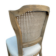 Close-up of Lilian Dining Chair showing woven rattan back and natural grain of the weathered oak frame.
