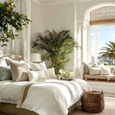 Neutral linen cushions styled on bed in light coastal bedroom interior