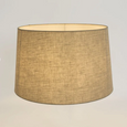 Linen Drum Lamp Shade Medium in Dark Natural illuminated to showcase its warm ambient glow and textured linen fabric.