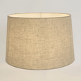 Linen Drum Lamp Shade Medium in Natural illuminated to showcase its warm, softly diffused glow and textured linen fabric.