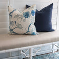 Linen Navy Cushion styled on a bench with a blue floral patterned cushion in a classic Hamptons-inspired interior