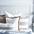 Linen Stripe Sand Cushion layered with white and natural cushions in a relaxed coastal bedroom