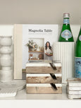 White marble utensil holder styled on kitchen shelf with books and marble accessories in coastal Hamptons home decor