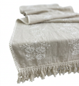 Natural embroidered table runner with fringe and tonal floral detail