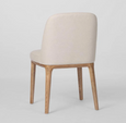 Beige upholstered dining chair with curved backrest and solid ashwood legs