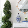 Close-up of the Marina Rattan Mirror with white rattan detailing styled above a white console table with decorative blue and white ceramics.