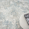Detailed view of the Marlowe Porcelain Rug medallion design in porcelain blue, ivory, pale grey and muted gold.