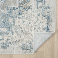 Reverse corner of the Marlowe Porcelain Rug showing its backing, finished edge and ivory blue patterned surface.