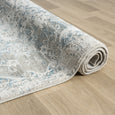 Rolled Marlowe Porcelain Rug showing its substantial multi-textured pile, finished edging and soft ivory blue palette.