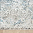 Close-up of Marlowe Porcelain Rug showing its soft multi-textured ivory and blue pile and finished edge.