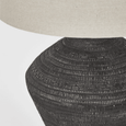Meridien ceramic table lamp with black finish and natural linen shade in styled home interior
