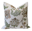 white cushion with olive botanical embroidery floral design front view