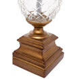 close-up of antique gold lamp base with carved detailing and glass centre