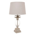 angled view of antique silver table lamp with glass pineapple detail and linen shade