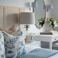 antique silver pineapple table lamp styled on bedside table with blue and white bedding and coastal decor