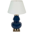 Midnight blue ceramic table lamp styled on a modern bedside table with warm ambient lighting