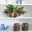 Ming Owl Ceramic 15cm Blue & White styled on a white shelving unit with wicker baskets, greenery and blue and white decorative accessories.