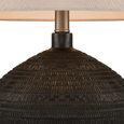 Modern black ceramic lamp with linen shade on bedside table creating warm ambient lighting