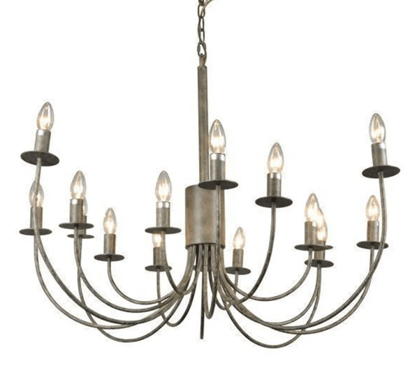 Modern iron chandelier with curved arm design hanging in a stylish entryway with warm ambient lighting
