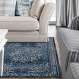 Monterey Navy Rug styled in a bright Hamptons living room with a cream sofa, blue patterned cushions and striped armchair accents