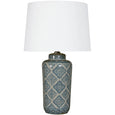 Motif ceramic table lamp with hand painted geometric base and white empire shade styled in a contemporary living room
