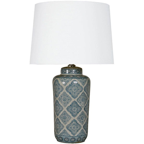 Motif ceramic table lamp with hand painted geometric base and white empire shade styled in a contemporary living room
