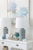 Motif ceramic bedside lamp with white empire shade styled on a bedroom side table
