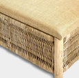 Close-up of handwoven rattan texture and hessian cushion on solid wood frame bench