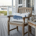 Nautical Whale Cushion styled on a timber verandah chair overlooking the water, creating a relaxed coastal Hamptons-inspired outdoor retreat with nautical décor accents.