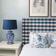 Classic navy lampshade creating warm ambient lighting in a living room

